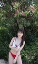 A woman in a red and white bikini posing for a picture.