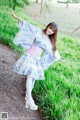 A woman in a blue and white kimono is posing for a picture.