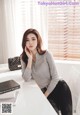 a woman sitting at a desk with a laptop