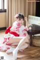 A woman in a kimono sitting on the floor.