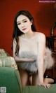 A woman sitting on top of a green couch.